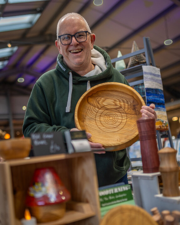 Artisan market stall displaying handmade wooden pieces