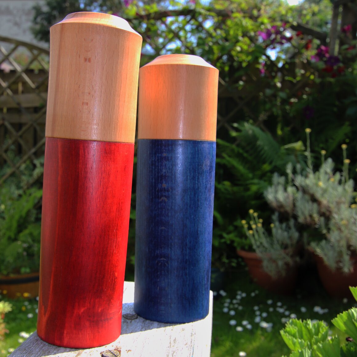Tall oak pepper mill standing on a dining table