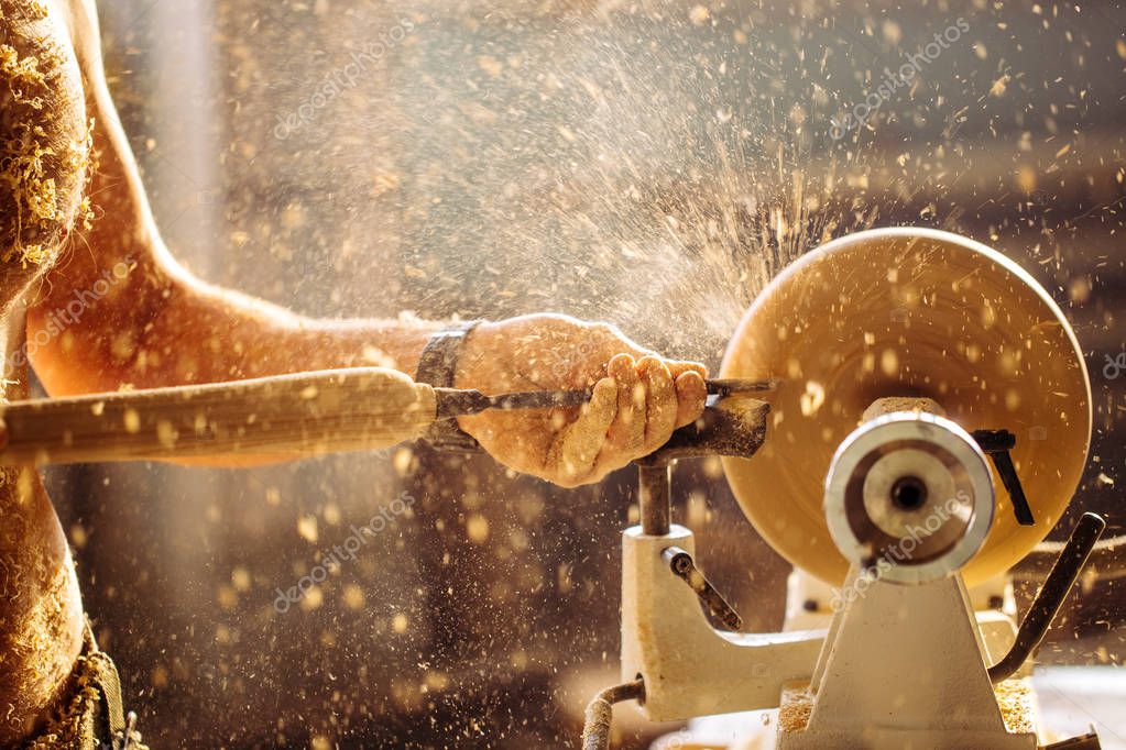 Hand-turned wooden bowl being shaped on a lathe