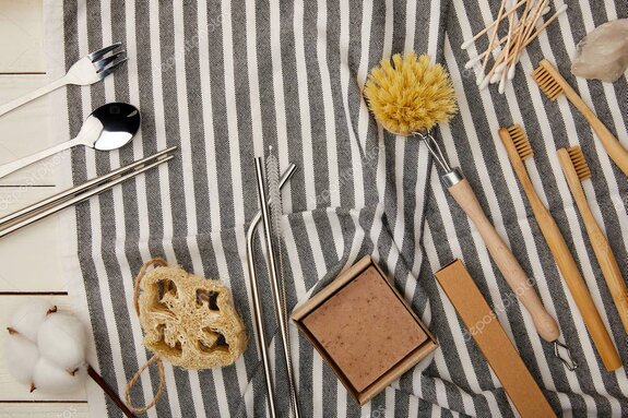 Person cleaning and oiling wooden kitchenware on a worktop