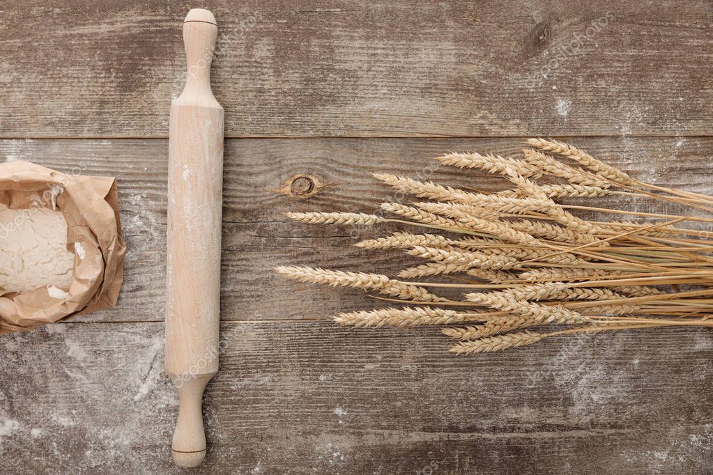 Ash wooden rolling pin beside baking ingredients