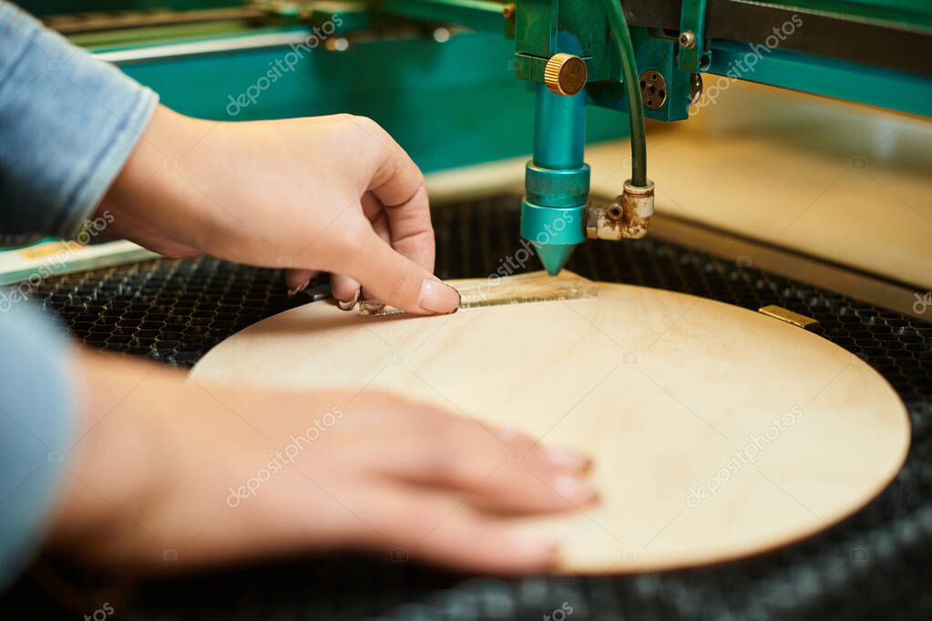 Laser engraving details onto a wooden board